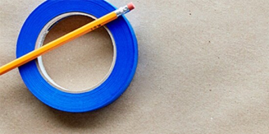 A pencil on a roll of Scotch® Painter's Tape.