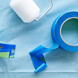 A paint roller, and two rolls of Scotch® Painter's Tape.