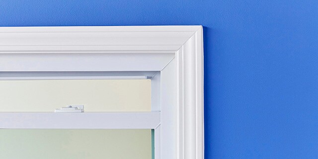 White window trim next to a blue wall.