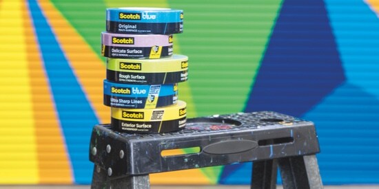Five rolls of Scotch® Painter's Tape on top of a ladder.
